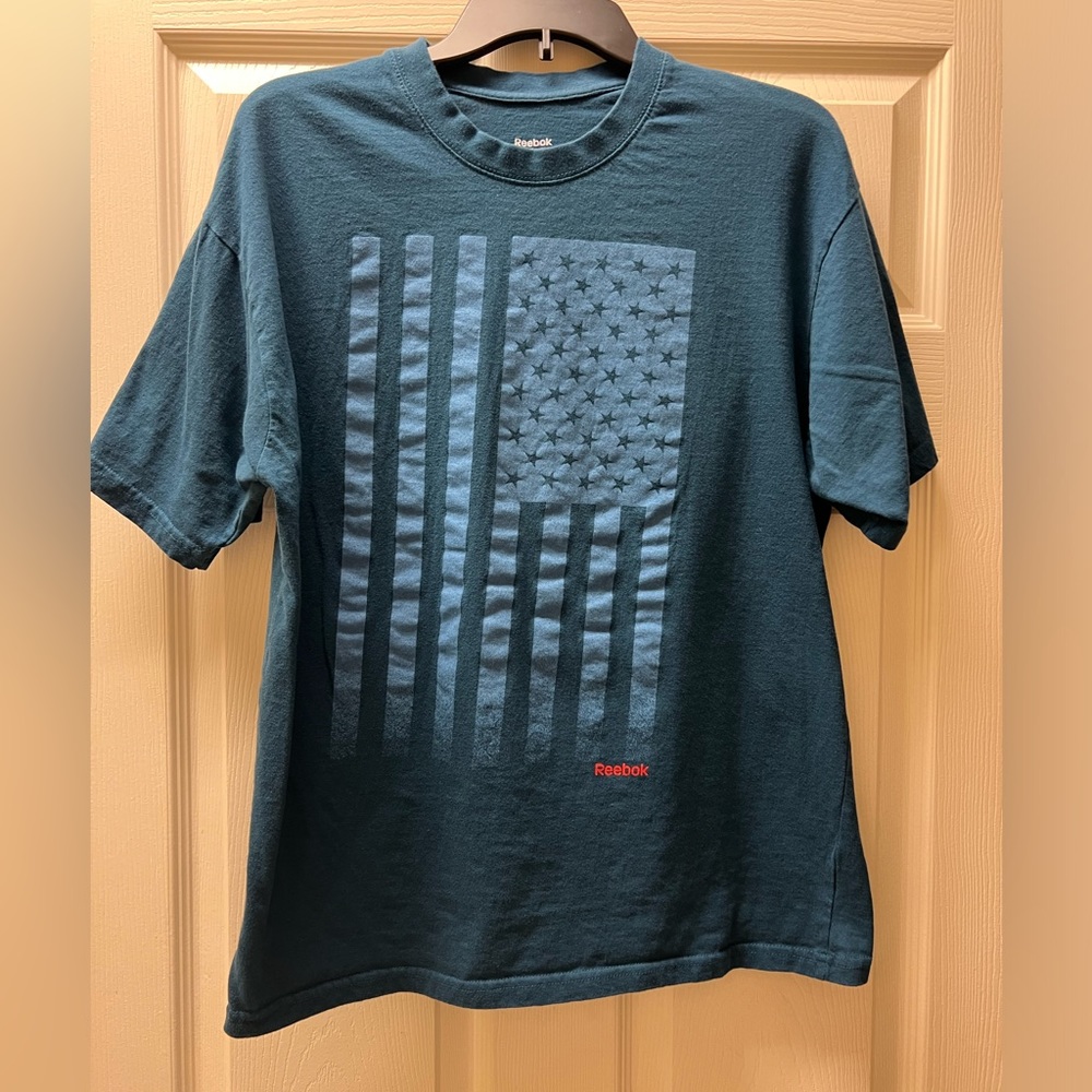 Men’s large blue Reebok t-shirt with flag on front.